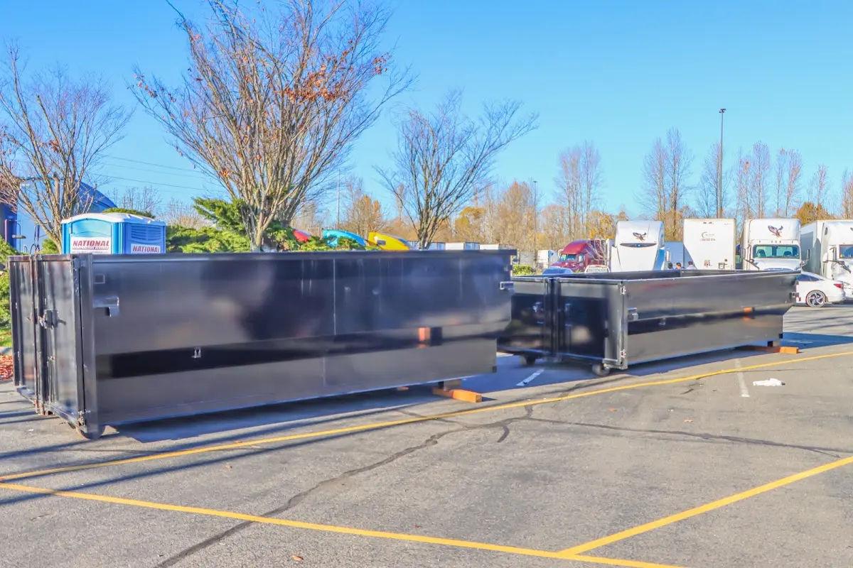 Professional dumpster rental service with roll-off container on residential driveway in Royal Kunia